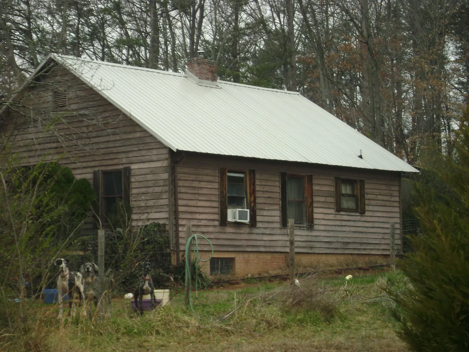 White metal roof on an old wood sided farmhouse, from a Metal Roof Installation job in Lake Andes